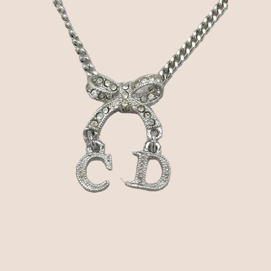 CHRISTIAN DIOR SILVER CRYSTAL INITIAL BOW PENDANT NECKLACE